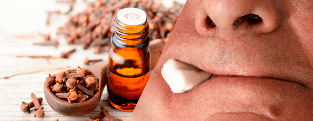 Bottle of clove oil next to an image of a mouth with a cotton swab soaked in the oil